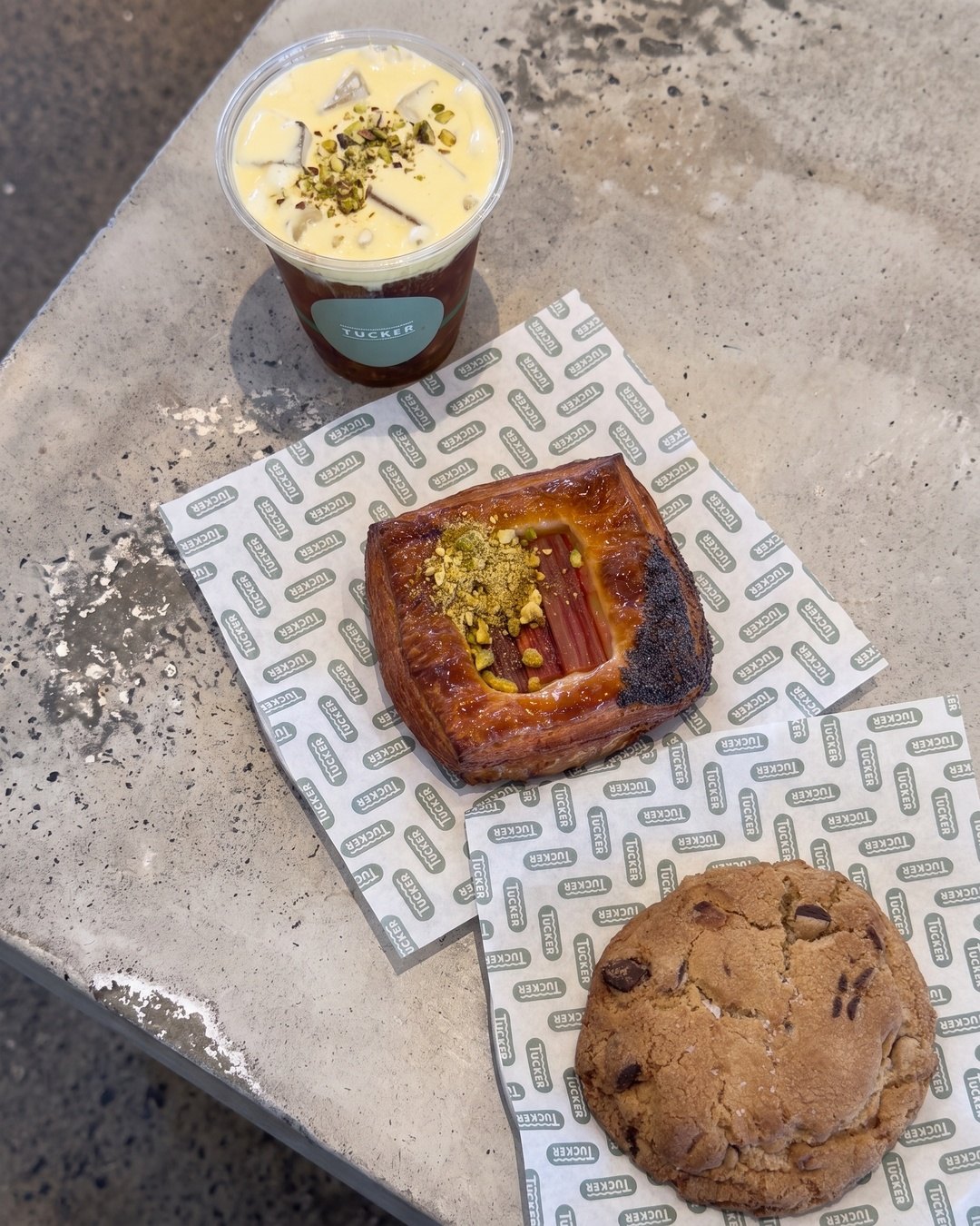 Rhubarb danish, choc chip cookie and pistachio cold brew on Tucker paper