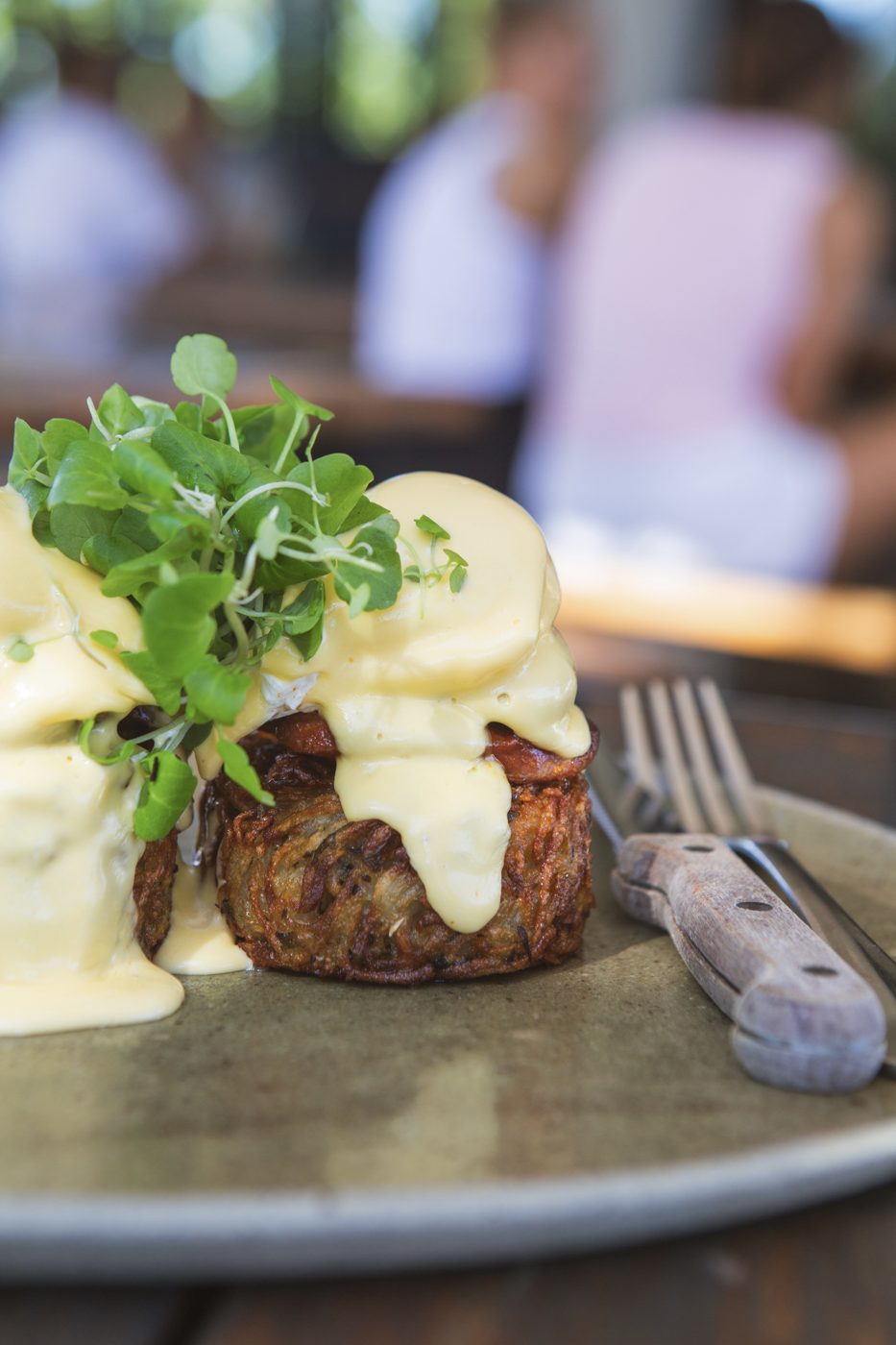 Rosti benedict at a table in the Tucker courtyard