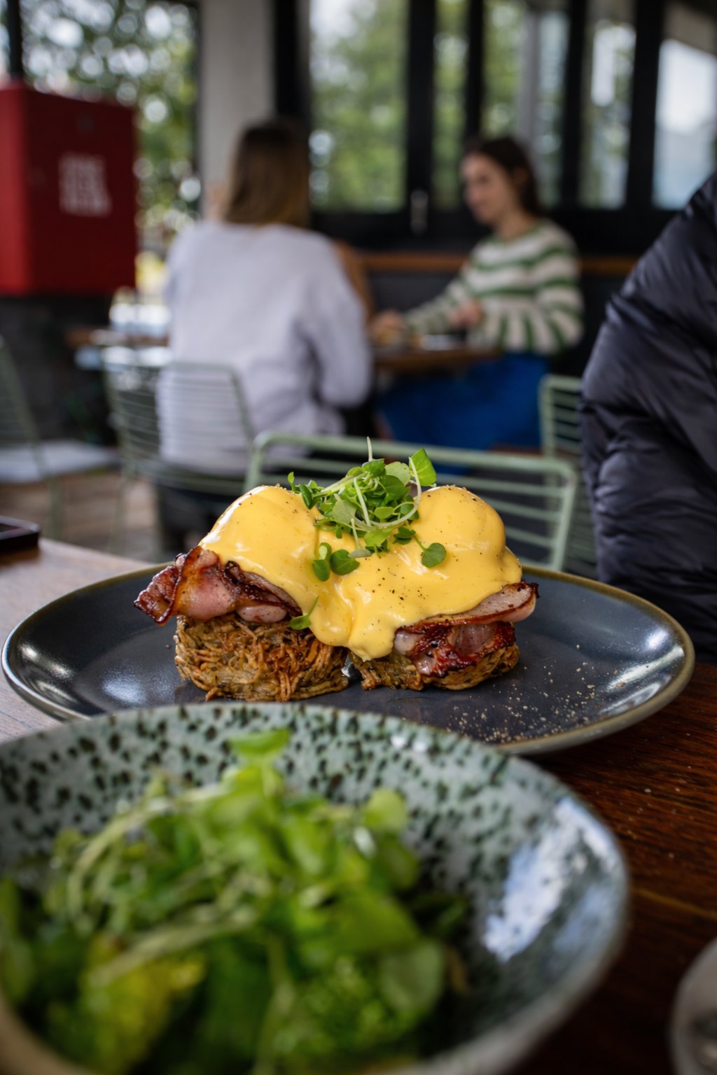 Rosti benedict at a table in the Tucker courtyard